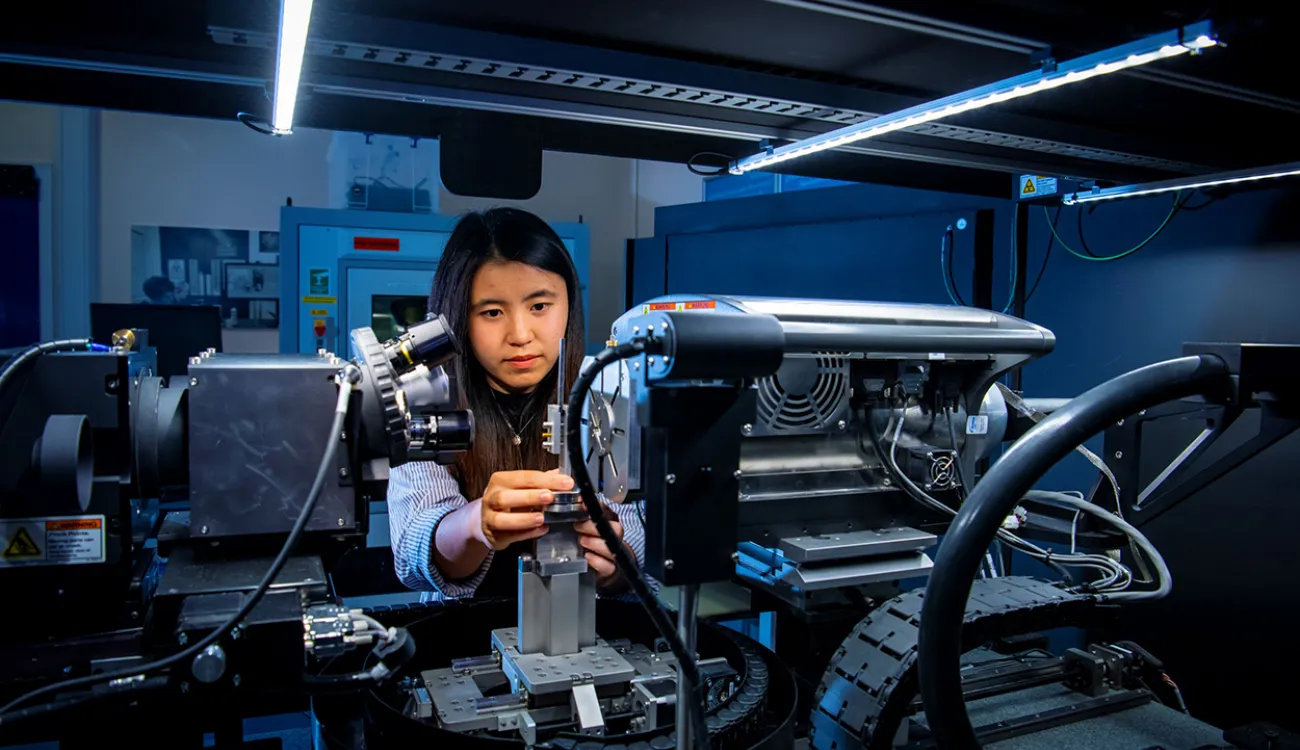 A mechanical engineering student uses a piece of complex machinery