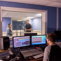 Students using the music recording suites to record a performance