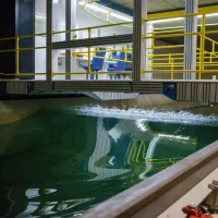 A rogue wave moves along the towing tank, with the carriage sitting above it