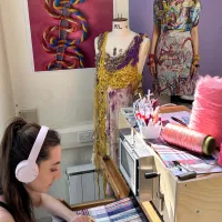 Student sat using textile's equipment and facilities at the Winchester School of Art.