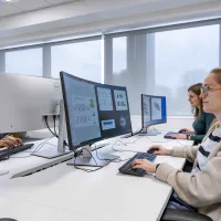 Students undertaking work at a computer station. 