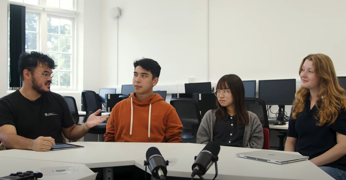 Student panel discussion, at a table with microphones.